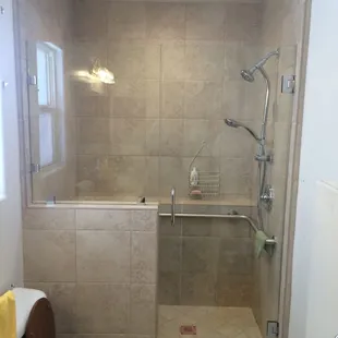 a walk in shower and toilet