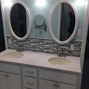 a bathroom with two sinks and mirrors