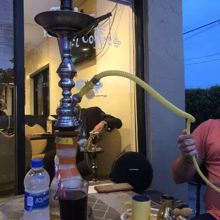 a man sitting at a table with a hook