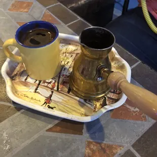 two cups of coffee on a tray