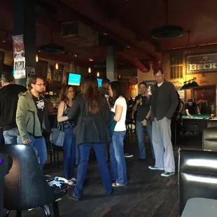 a group of people standing around a bar