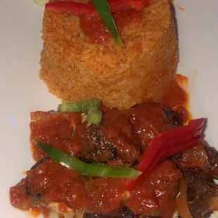 Goat stew with jollof rice and salad