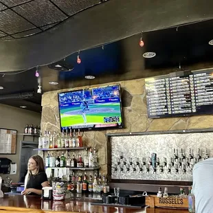 a bar with people sitting at the bar