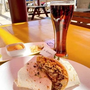 a plate of food and a glass of beer