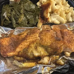 a meal of chicken, macaroni and cheese and greens