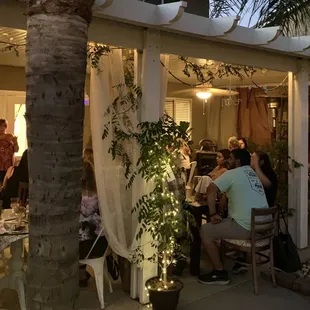 a group of people sitting outside a restaurant