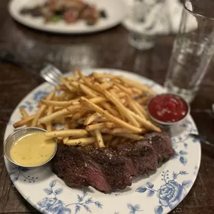a steak with fries and ketchup