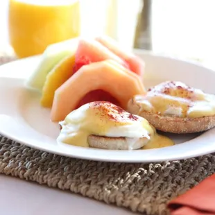 Eggs Benedict. Two Poached Eggs atop Canadian Bacon, Homemade Hollandaise Sauce. Toasted English Muffin.