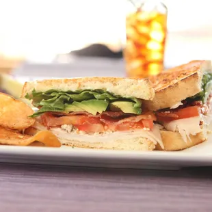 Quarry Club. Oven roasted turkey, applewood smoked bacon, Swiss cheese, lettuce and tomatoes on toasted white bread.