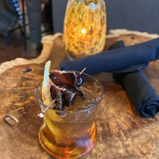 a glass of whiskey with bacon