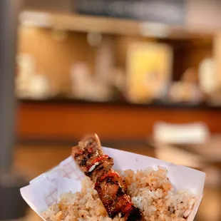 a hand holding a piece of food