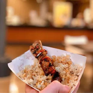 a hand holding a piece of food