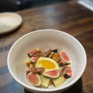 a bowl of figs and an egg
