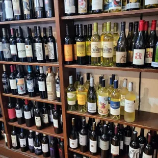 a shelf full of wine bottles