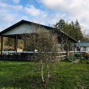 Covered outdoor eating patio with the Rex beyond