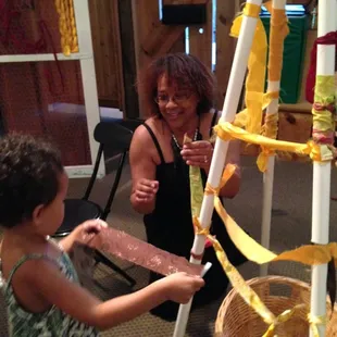 A young traveler is helping Rachael with the building of the Weavers Hut