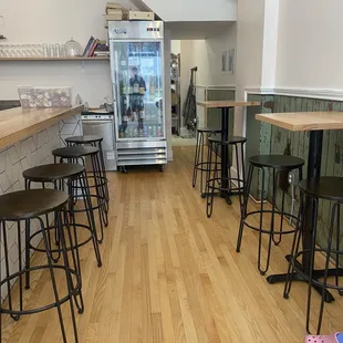 a kitchen with a refrigerator and bar stools