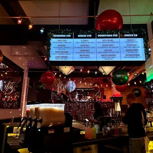 a bar with a menu on the wall