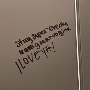 a bathroom stall with a message written on it