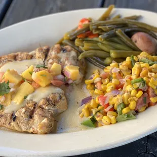 Popular wedding option - grilled chicken breast with cream sauce and mango pico de gallo.