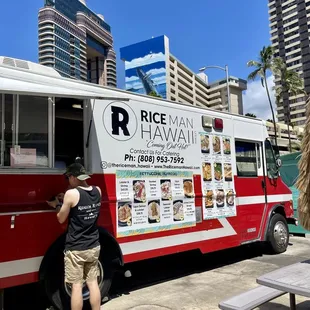 a man standing in front of a food truck