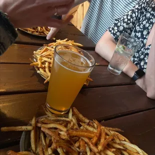 a plate of fries and a glass of beer