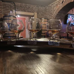 a row of wine glasses on a bar