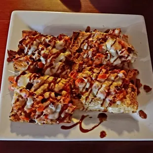 Brushetta - an appetizer of crunchy, fresh bread, diced tomatoes, melted cheese and a balsamic glaze.
