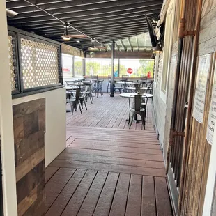 a patio with tables and chairs