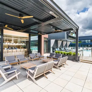 a patio with a dining table and chairs