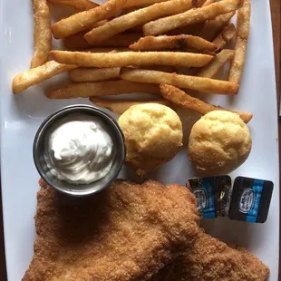 Fried cod fish with fries and homemade corn muffins.