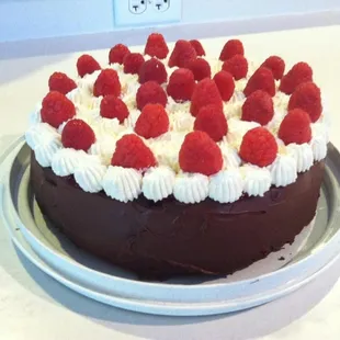 a chocolate cake with raspberries on top