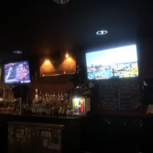 a bar with several televisions