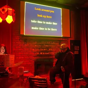 two people standing in front of a screen