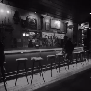 a black and white photo of a bar