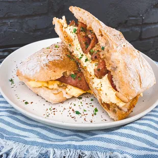 scrambled eggs,  andouille sausage, remoulade, aged cheddar, ciabatta