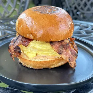 crispy bacon, white cheddar (vegan cheese option), &amp; house remoulade with a fluffy egg on a brioche bun