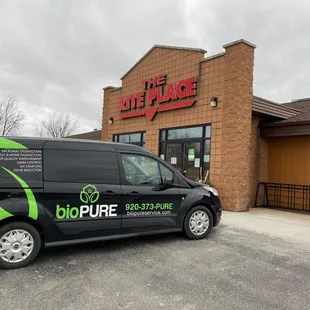 a van parked in front of the store