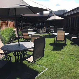 a patio with chairs and umbrellas