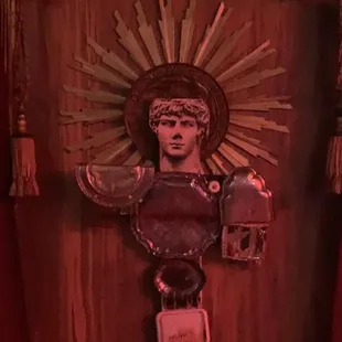 a statue of jesus on a wooden wall