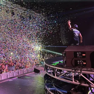 a man on a stage surrounded by confetti