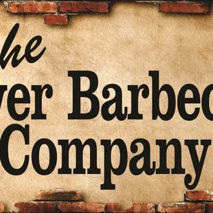 a brick wall with a sign that says the river barbecue company