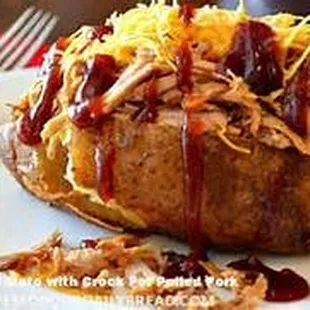 River Spud - Baked potato topped with shredded cheese, pulled Pork BBQ, Our Homemade Sweet Sauce, Bacon Bits, Sautéed onions, Chives