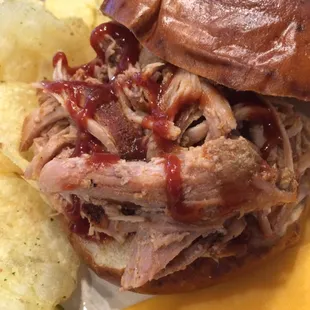 Slow roasted, pulled pork on a pretzel roll