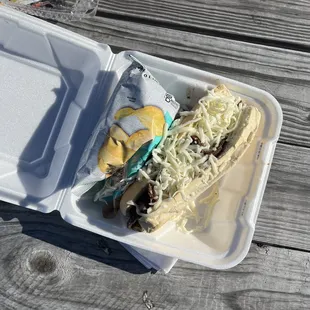 a sandwich in a styrofoam container