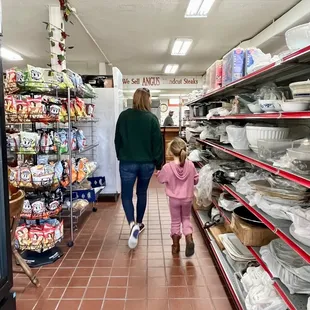 a woman and a child walking down the aisle