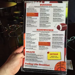 a hand holding a menu