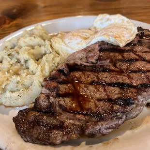 Ribeye steak and eggs with green chili potatoes