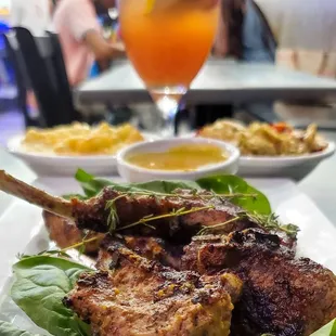 a plate of food and a glass of orange juice