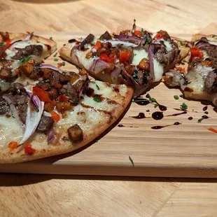 two pieces of pizza on a cutting board